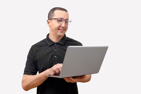 Young man using laptop on white background.の写真素材