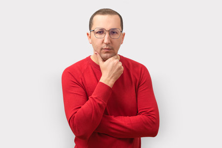 Confident man looking at camera on gray background.の写真素材