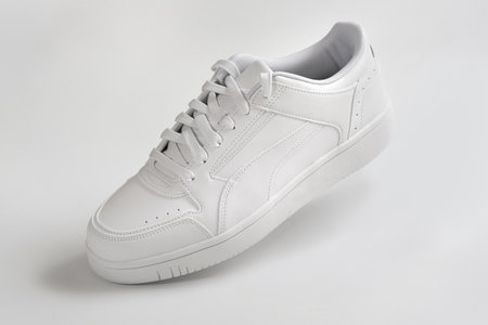 White sneaker on a light background close up.の写真素材