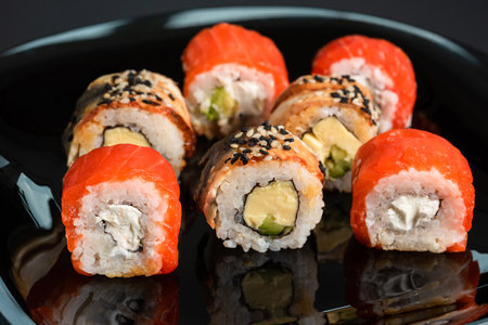 Traditional sushi rolls on a black background. Japanese foodの写真素材