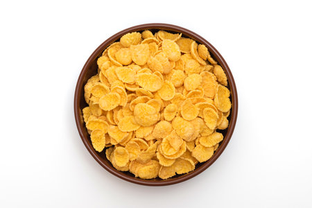 A plate of corn flakes in a plate on a white backgroundの写真素材