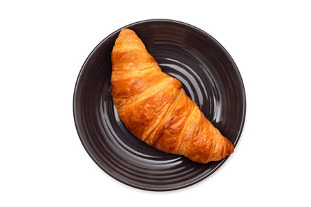Croissant in a plate isolated on white background. Top view.の写真素材