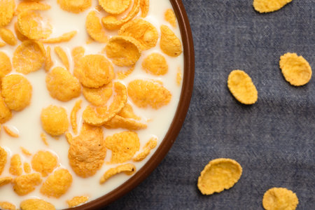 Corn flakes with tar in a bowl close-up. Top view