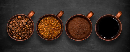 Set of takeaway black coffee cups on a dark background, top viewの写真素材