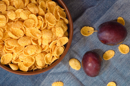 Bowl of cornflakes on the table, top view. Healthy crispy breakfast snackの写真素材