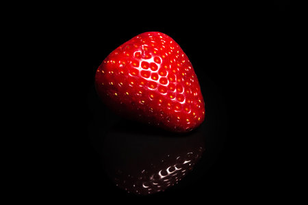 Ripe strawberry on a black background. Organic fruitsの写真素材
