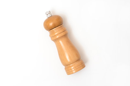 Wooden pepper mill isolated on white background, top view.の写真素材