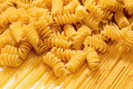 Background texture of raw spaghetti fusilli, close-upの写真素材