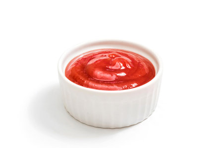 Ketchup in white bowl isolated on white background. Bowl of tomato sauce close up