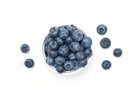 Bowl of fresh blueberries on white. Top viewの写真素材