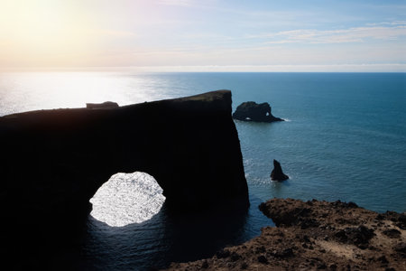 Rock arch in the Atlantic Ocean in southern Iceland.の写真素材