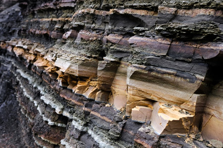 Textured natural background of a rock wall with cracksの写真素材