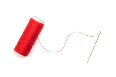Sewing needle with red thread isolated on white, top viewの写真素材