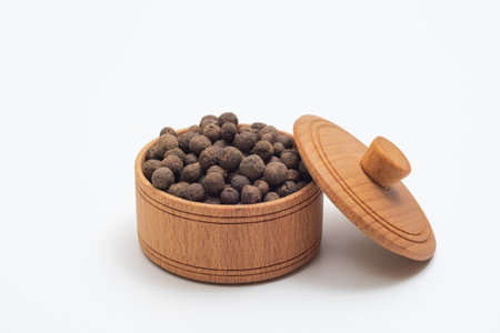 Bowl of black allspice on white background. Spices close-upの写真素材