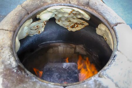 Baking tandoor bread in arabic tandoor in Israel. Traditional arabic Laffa breadの写真素材