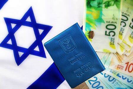 Teudat Zehut (Israeli passport) on the Israeli shekel (currency ILS) and flag of Israel. Photo Themes: Israeli citizenship, Israeli citizen, economy in Israel, business in Israel, currency exchangeの写真素材
