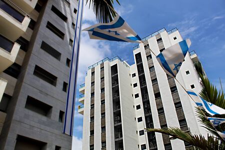 Concepts: Modern residential apartment buildings and Israeli Independence Day. New residential area in Israel. Israeli Modern residential apartment buildings, Flags of Israelの写真素材
