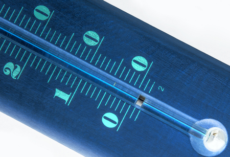Blue thermometer on a black background