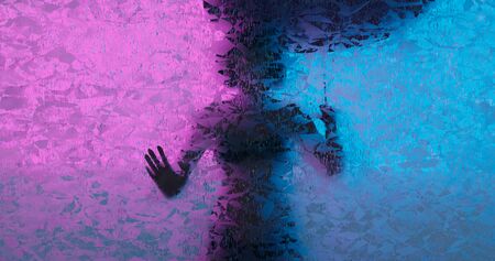 3d rendering. Silhouette of a woman with an umbrella from the rain behind a glass wall or frosted...