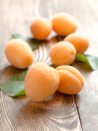 Ripe apricots on wooden  backgroundの写真素材