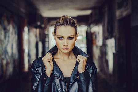 Beautiful girl with blue eyes close up on blurred backgroundの写真素材