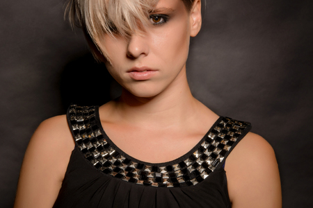 Close-up of a girl with a short haircut. Dark backgroundの写真素材