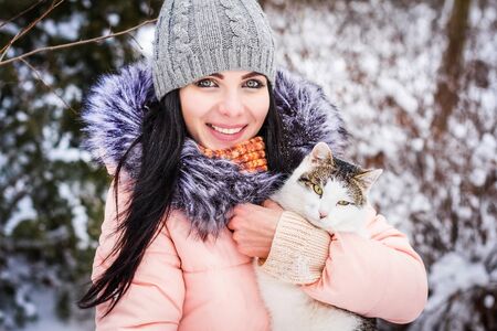 Winter. Girl brunette capless smiles on the background of snow. Close-upの写真素材