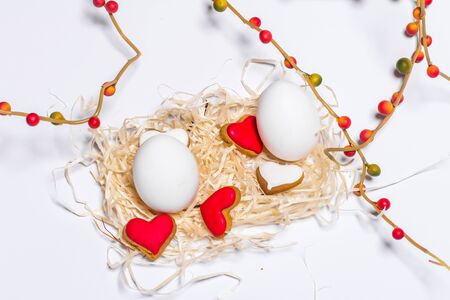 Easter card with eggs and biscuits in the form of heart. Close-upの写真素材