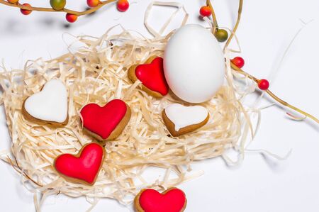 Easter card with eggs and biscuits in the form of heart. Close-upの写真素材