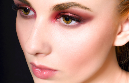 Beautiful girl with a pink make-up and smooth hair with a large planeの写真素材