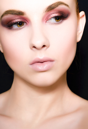 Beautiful girl with a pink make-up and smooth hair with a large planeの写真素材