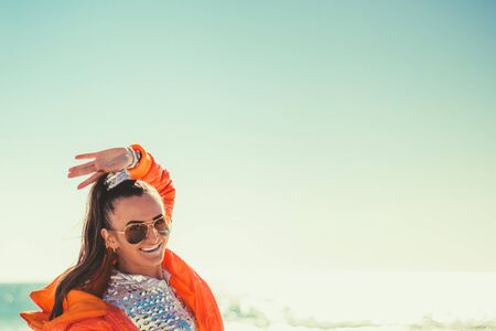 Woman smiling against the sea and sky backgroundの写真素材