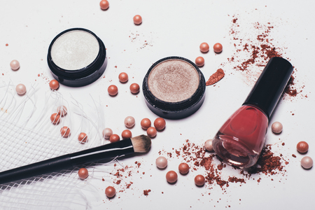 Scattered shadows, applicator, rouge balls and nail polishの写真素材