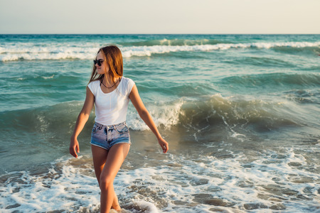 Girl With Long Hair on the background of the sea sunset  close upの写真素材