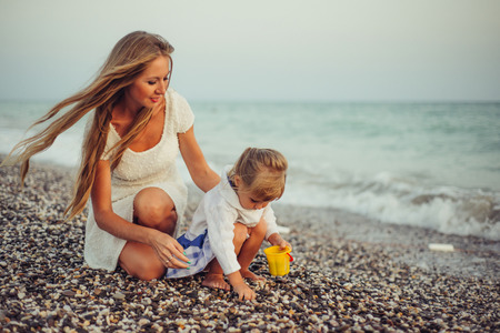 Mom with daughter near the sea close upの写真素材
