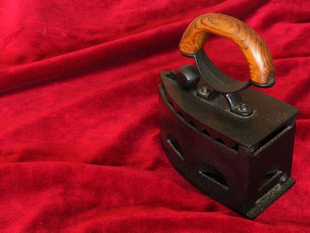 Old iron on a red velvet background.の写真素材