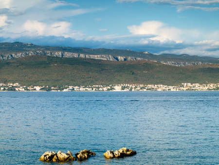An island view across the sea to mainlandの写真素材