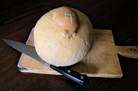 Cutting a seasoned italian cheeseの写真素材