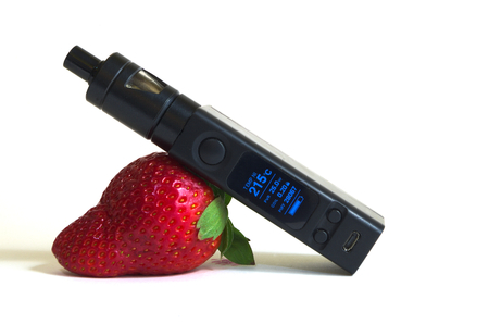 Electronic cigarette lying on a strawberryの写真素材