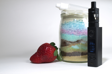 Electronic cigarette with sugar and strawberryの写真素材