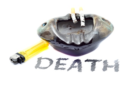 Overhead of burning cigarette in ashtray and lighter on white background with DEATH textの写真素材