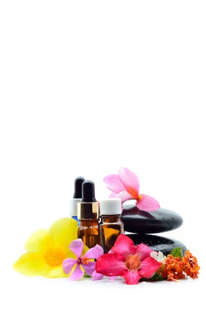 Essence oil and flower with zen stone isolated on whiteの写真素材