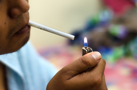Man lighting up cigaretteの写真素材