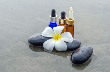Essential oil with white frangipani flower and zen stonesの写真素材
