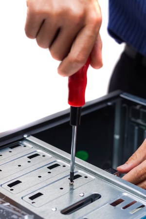 Close-up of technician's hand assembling personal computerの写真素材