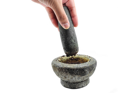 hands with a pestle and mortar on whiteの写真素材