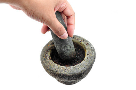 hands with a pestle and mortar on whiteの写真素材