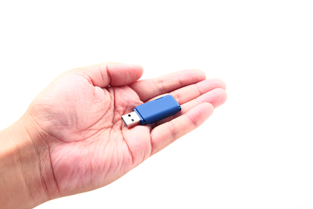 Hand holding USB data storage or connecting computer device with USB cable, isolated on white...