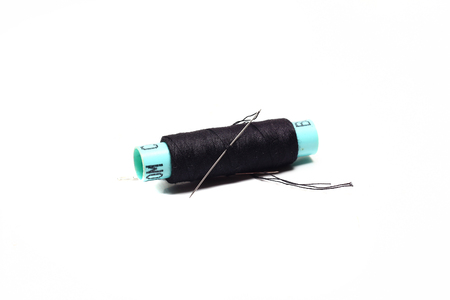 Black bobbin and needle on a white background