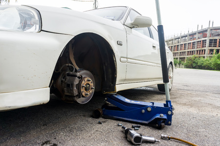 Closeup detail of the wheel assembly on a modern automobile. The rim is removed showing the front rotor and caliper.の写真素材